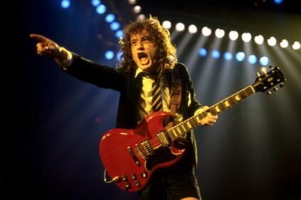 DETROIT - NOVEMBER 17: Angus Young, the Australian musician, best known as the co-founder, lead guitarist, and songwriter of the Australian hard rock band AC/DC, onstage at the Joe Louis Arena during the band's "Flick of the Switch/Monsters of Rock" tour, on November 17, 1983, in Detroit, Michigan.  (Photo by Ross Marino/Getty Images)